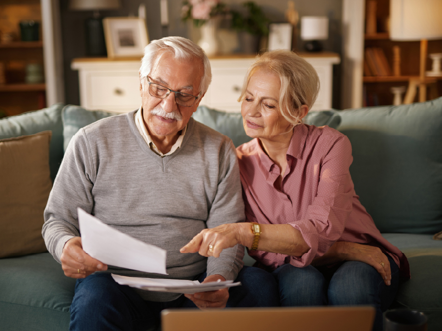 elderly couple looking at important documents