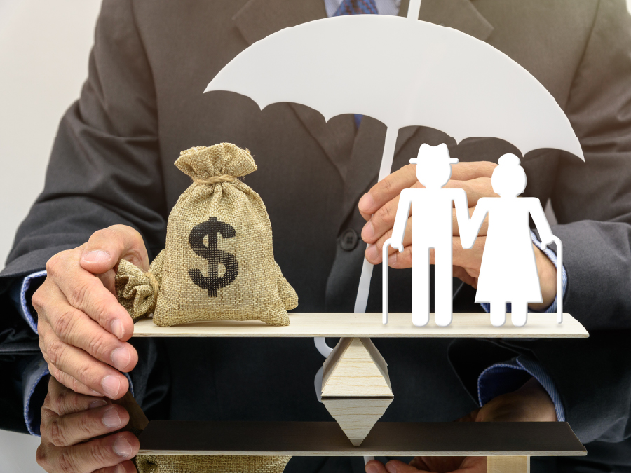 a picture of a scale balancing a bag of money and two figures holding an umbrella