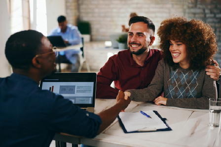 a young couple speaking with their financial advisor